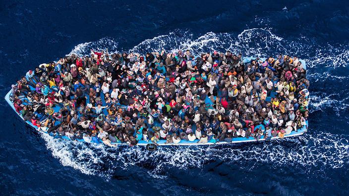 4/Hundreds of refugees and migrants aboard a fishing boat are pictured moments before being rescued by the Italian Navy as part of their Mare Nostrum operation in June 2014. Among recent and highly visible consequences of conflicts around the world, and the suffering they have caused, has been a dramatic growth in the number of refugees seeking safety by undertaking dangerous sea journeys, including on the Mediterranean. 
The Italian Coastguard / Massimo Sestini