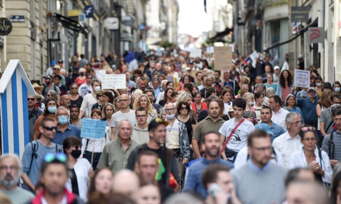 Demonstrators hold placards and chant slogans as they march during a rally in Nantes, western France, on September 18, 2021, to protest against the mandatory Covid-19 health pass to access most of the public space. (Photo by Sebastien SALOM-GOMIS / AFP) (Photo by SEBASTIEN SALOM-GOMIS/AFP via Getty Images)