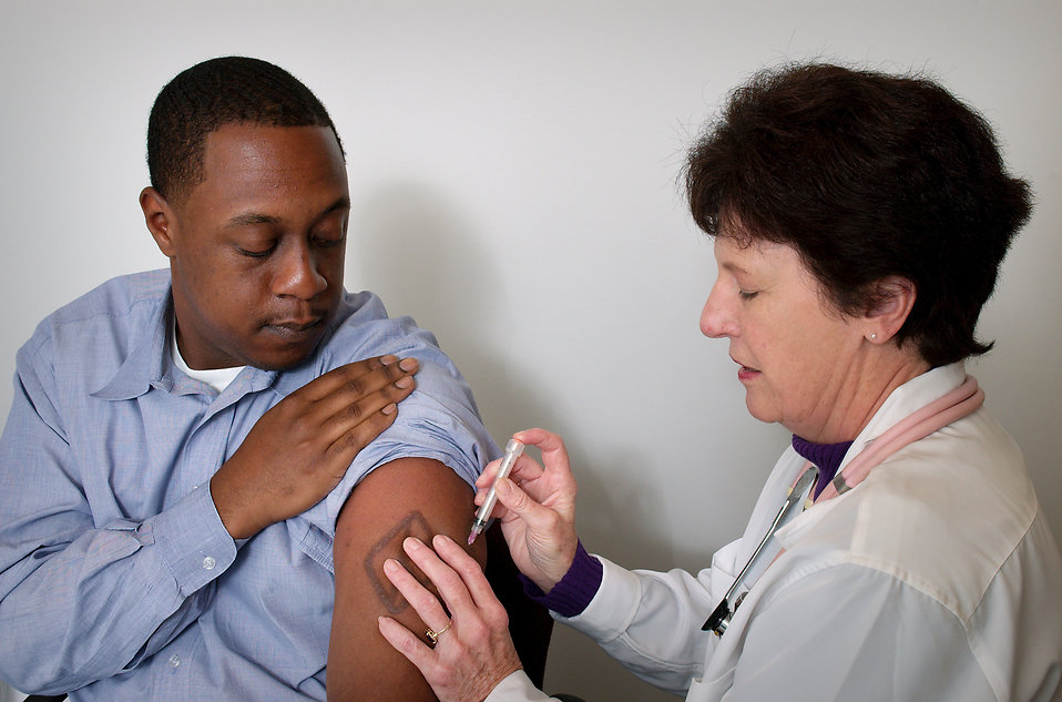 man-receiving-a-vaccination-shot-from-his-doctor